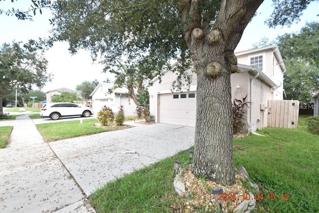 504 Maple Pointe Dr, Seffner, FL 33584 - view of home's exterior with driveway, a lawn, stucco siding, and an attached garage