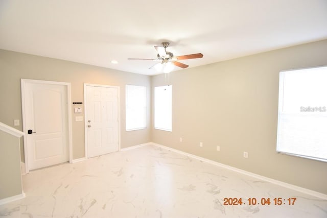 504 Maple Pointe Dr, Seffner, FL 33584 - empty room with light marble finish floors, a ceiling fan, healthy amount of natural light, and recessed lighting