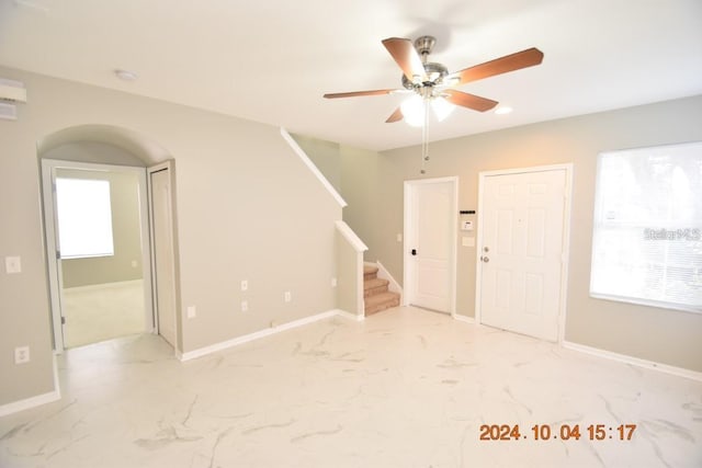 504 Maple Pointe Dr, Seffner, FL 33584 - entryway with a ceiling fan, marble look tile flooring, stairs, and baseboards
