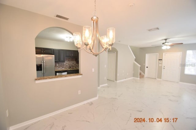 504 Maple Pointe Dr, Seffner, FL 33584 - unfurnished dining area featuring arched walkways, a ceiling fan, a chandelier, stairs, and baseboards