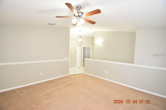 spare room featuring carpet flooring, ceiling fan, and lofted ceiling