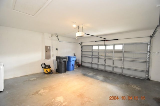 garage with electric panel and a garage door opener