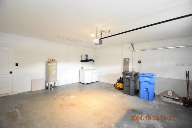 garage featuring separate washer and dryer, water heater, electric panel, and a garage door opener