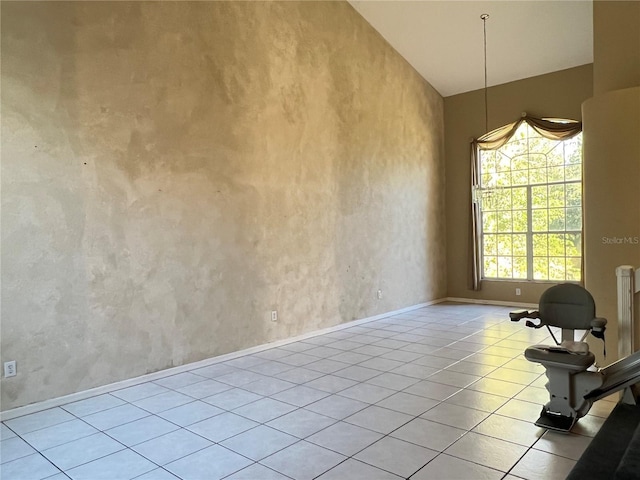 interior space featuring light tile patterned floors and vaulted ceiling