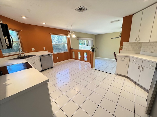 kitchen featuring dishwasher, white cabinets, decorative light fixtures, and sink