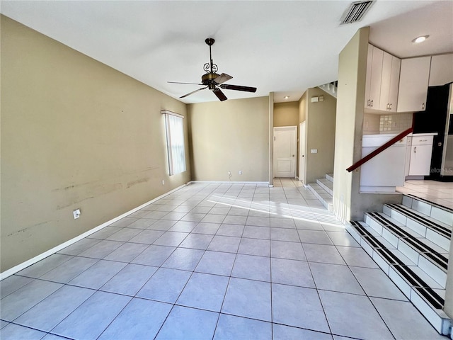 unfurnished living room featuring ceiling fan and light tile patterned flooring