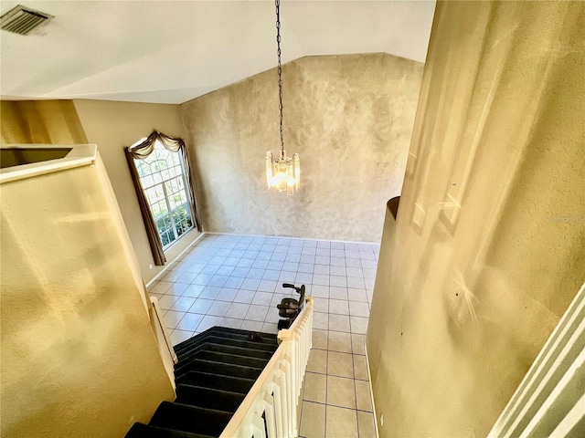 interior space featuring tile patterned flooring and lofted ceiling