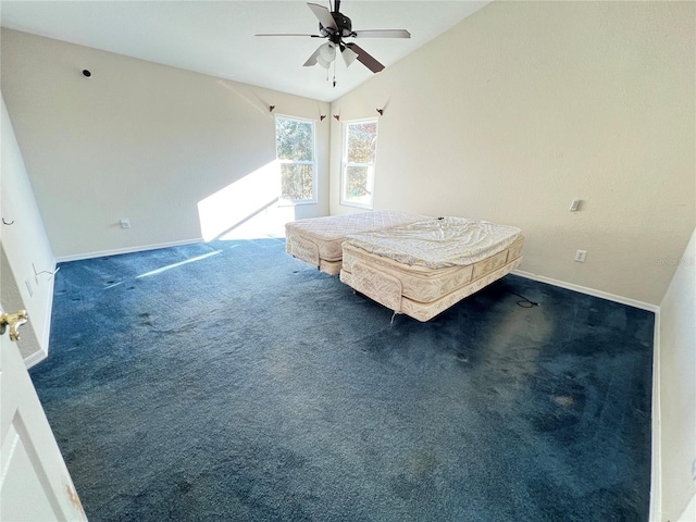 unfurnished bedroom featuring dark colored carpet, ceiling fan, lofted ceiling, and pool table