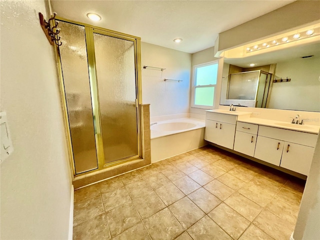 bathroom with tile patterned floors, vanity, and shower with separate bathtub