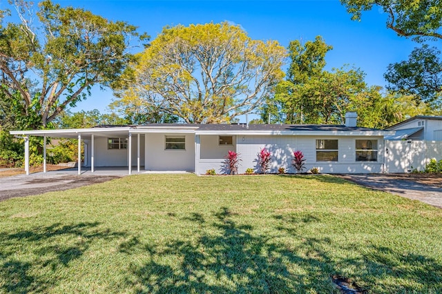 ranch-style house with a carport and a front lawn