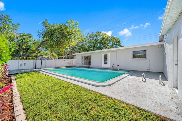 view of swimming pool with a yard and a patio area