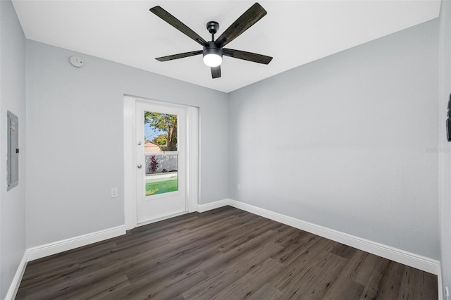 empty room with dark hardwood / wood-style floors and ceiling fan