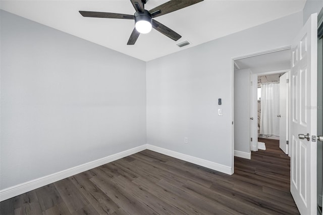 unfurnished room with dark hardwood / wood-style floors and ceiling fan