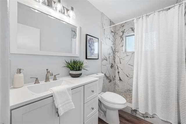 bathroom featuring hardwood / wood-style floors, vanity, curtained shower, and toilet