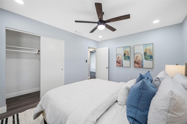 bedroom with ceiling fan, a closet, and dark wood-type flooring