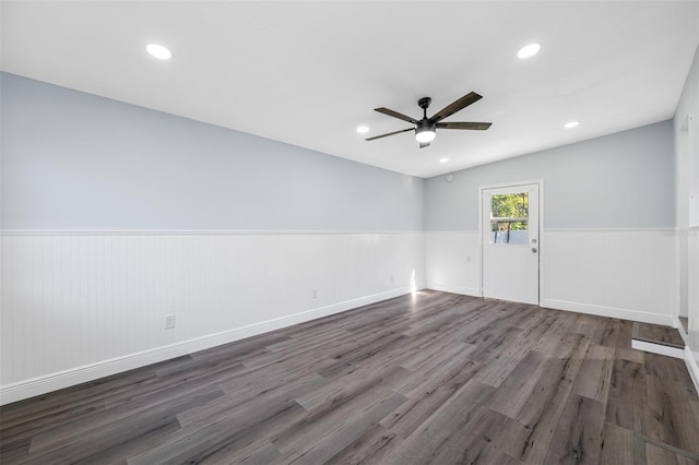 unfurnished room with ceiling fan and dark wood-type flooring