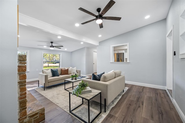 living room featuring ceiling fan and dark wood-type flooring