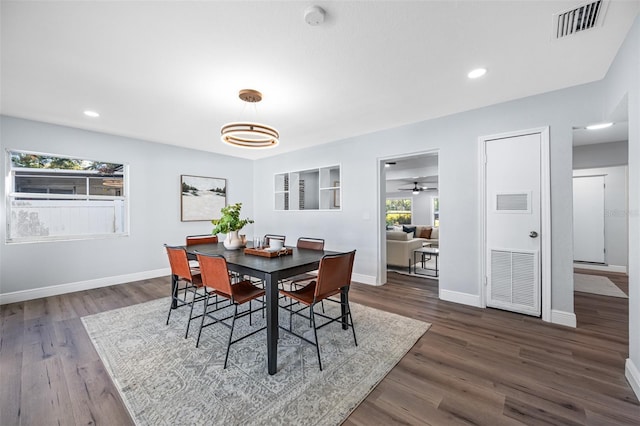 dining space with ceiling fan, dark hardwood / wood-style flooring, and a wealth of natural light