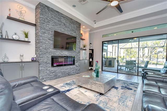 living room featuring a fireplace, hardwood / wood-style flooring, and crown molding