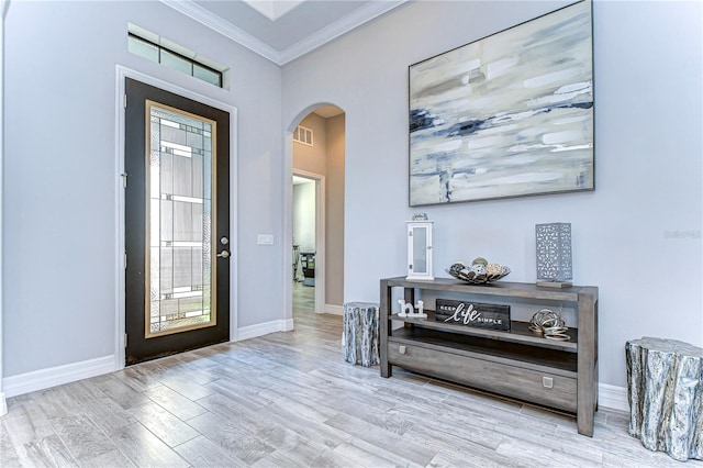 entryway featuring crown molding and light hardwood / wood-style flooring