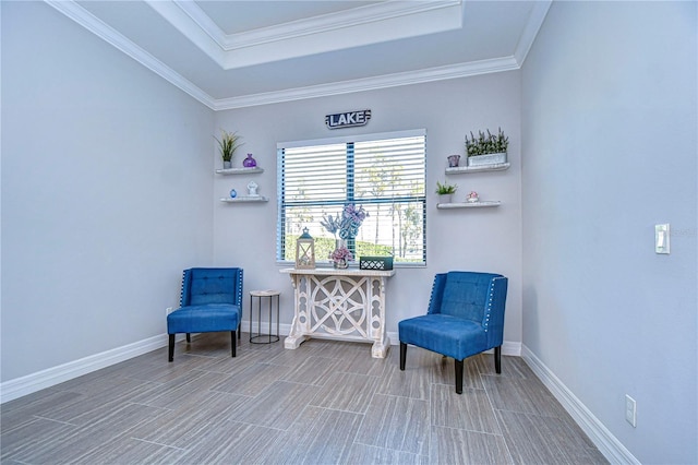 living area featuring hardwood / wood-style floors, a raised ceiling, and crown molding