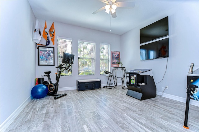 exercise room with ceiling fan and wood-type flooring