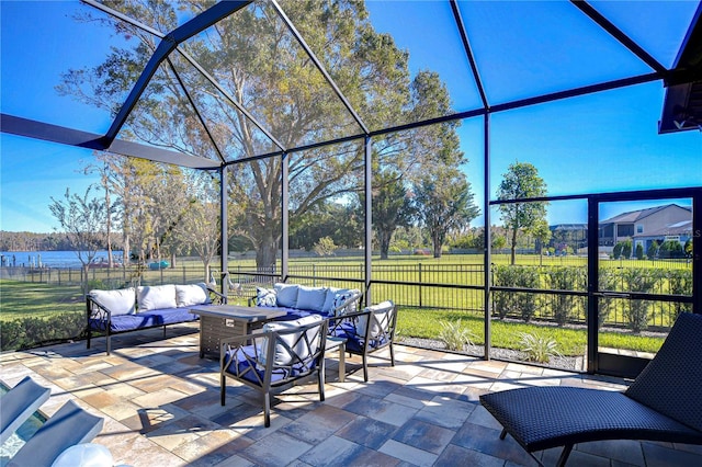 view of patio with outdoor lounge area and glass enclosure