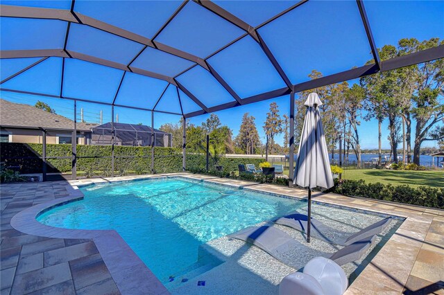 view of swimming pool featuring a lanai and a patio area