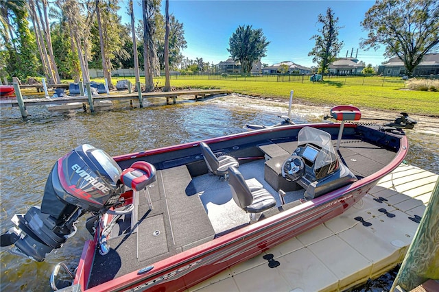 view of dock featuring a lawn and a water view