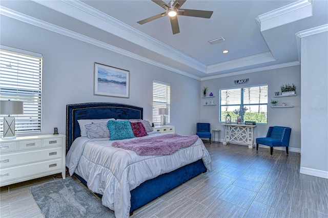 bedroom with a raised ceiling, ceiling fan, hardwood / wood-style floors, and ornamental molding