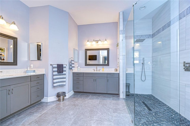 bathroom featuring tiled shower and vanity