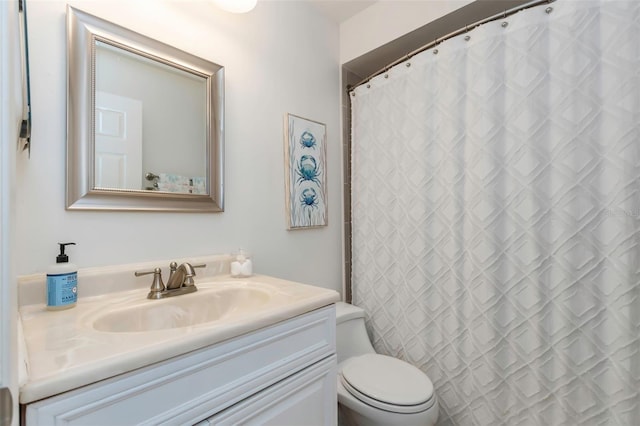 bathroom with vanity, a shower with shower curtain, and toilet