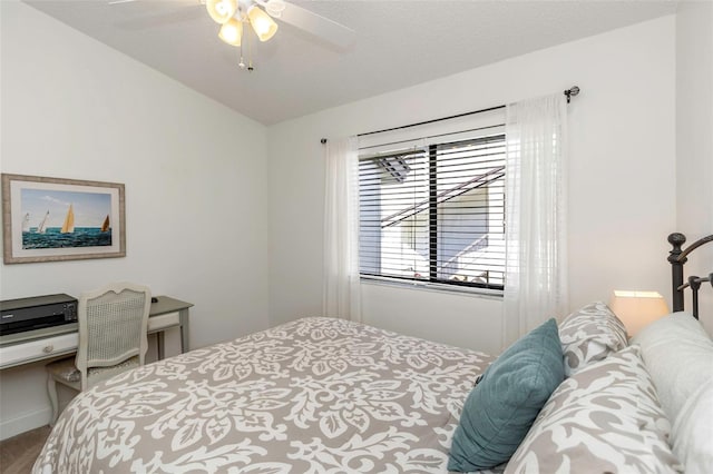 bedroom with ceiling fan and a textured ceiling