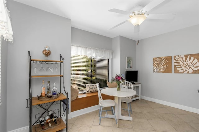 tiled dining area featuring ceiling fan