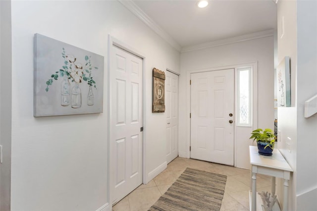 tiled entrance foyer featuring ornamental molding