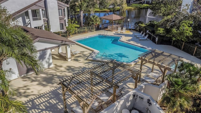 view of swimming pool featuring a water view and a patio area