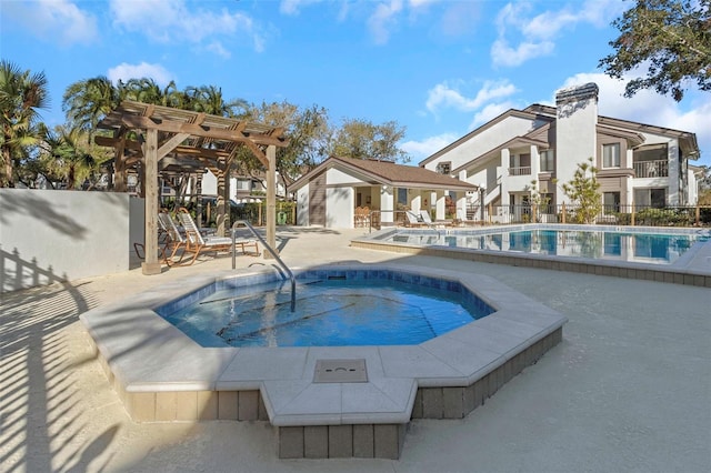 view of swimming pool with a pergola and an outdoor structure