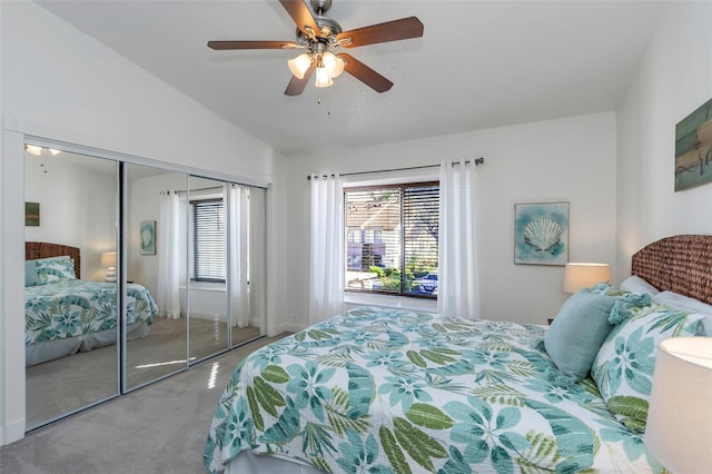 bedroom with carpet, a closet, vaulted ceiling, and ceiling fan