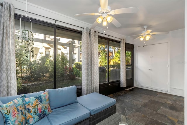 interior space with ceiling fan