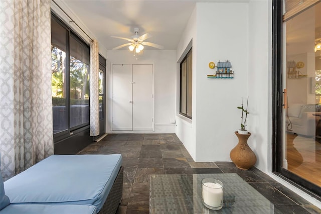 sunroom with ceiling fan