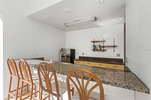 kitchen featuring stainless steel refrigerator and sink