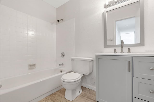 full bathroom with tiled shower / bath combo, toilet, and vanity