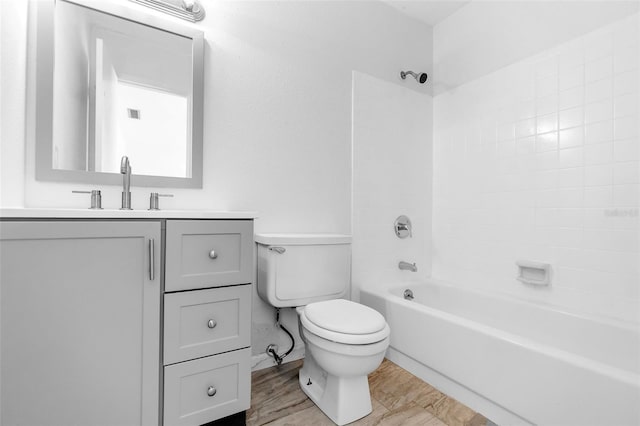 full bathroom with vanity, tiled shower / bath combo, and toilet