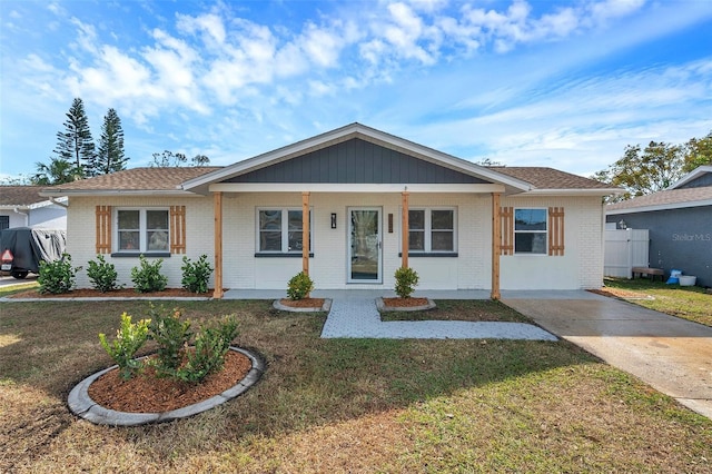 ranch-style house with a porch and a front yard