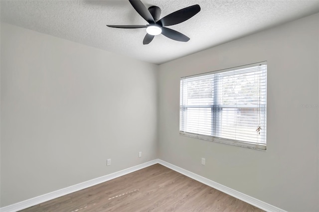 unfurnished room featuring ceiling fan, a textured ceiling, and light wood-type flooring