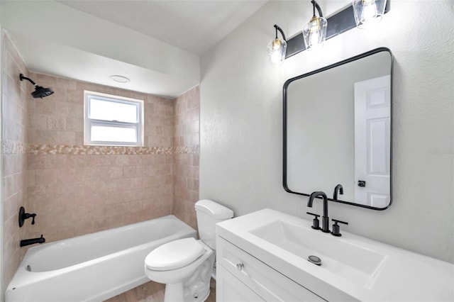 full bathroom featuring vanity, toilet, and tiled shower / bath