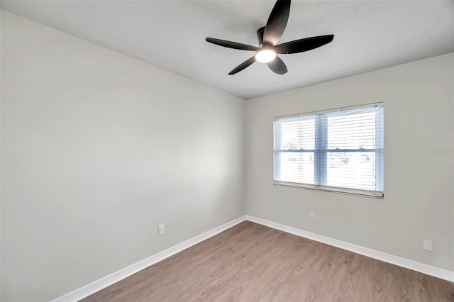 spare room featuring ceiling fan and light hardwood / wood-style flooring