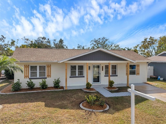 ranch-style house with covered porch and a front lawn