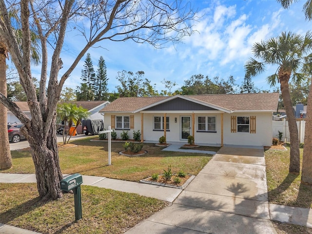 ranch-style house with covered porch and a front lawn