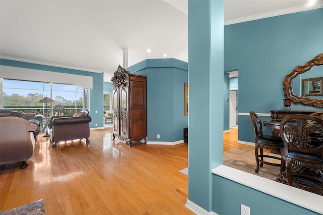 living room featuring light wood-type flooring and crown molding